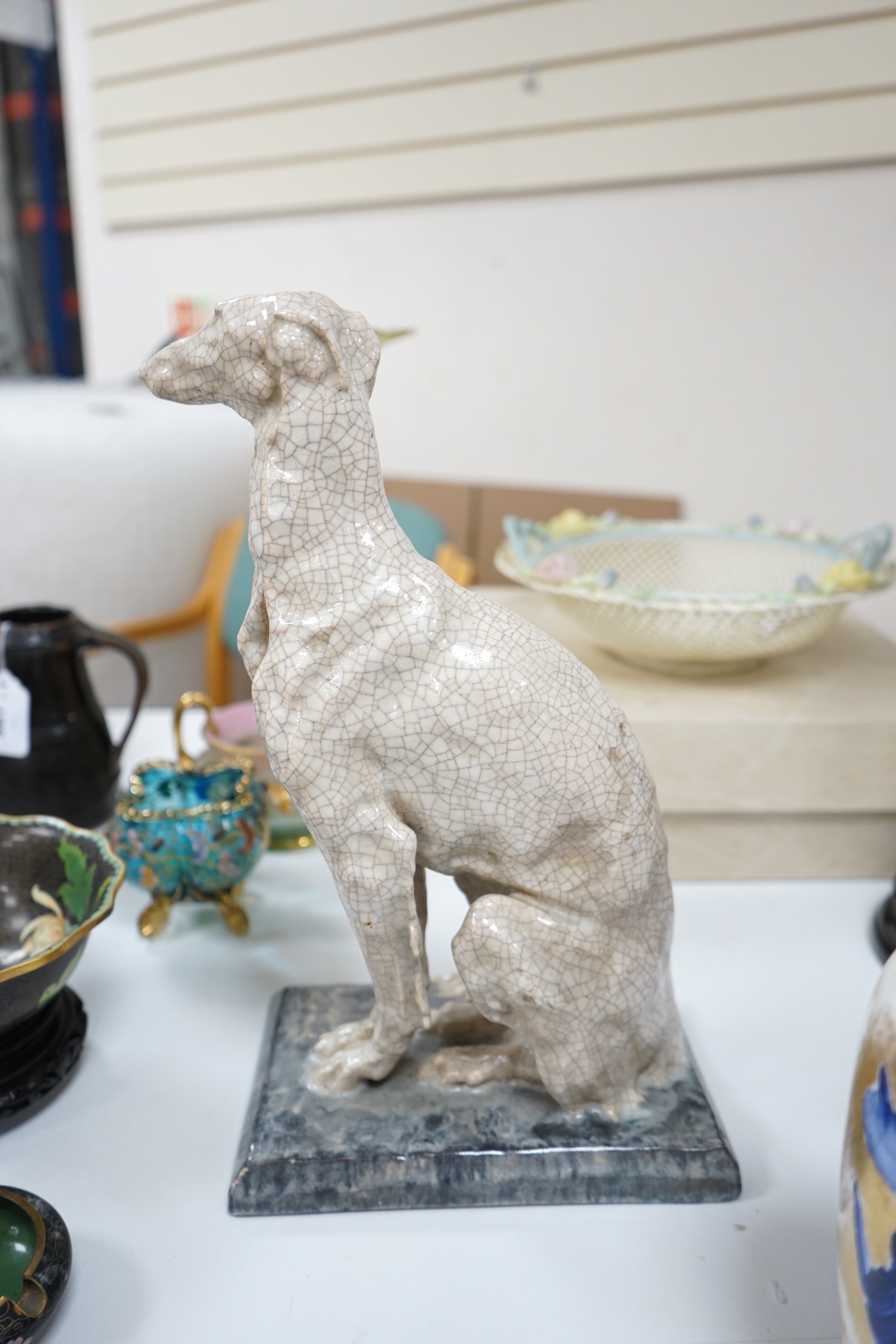 Louis Henri Nicot, Paris, a porcelain crackleglaze greyhound, signed to the base and with ‘Editions Erune Paris’ triangular stamp to the base along with a second incised signature, 35cm high. Condition - good.